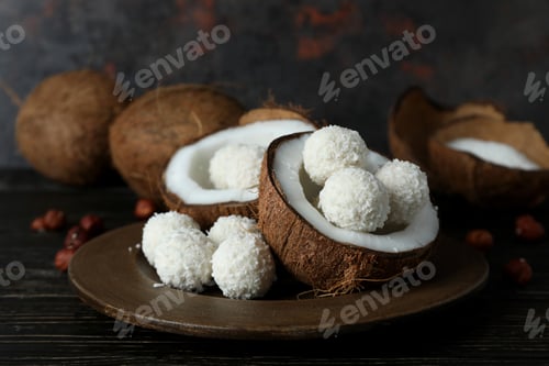 Preview: Concept of tasty sweets on wooden table, coconut candies