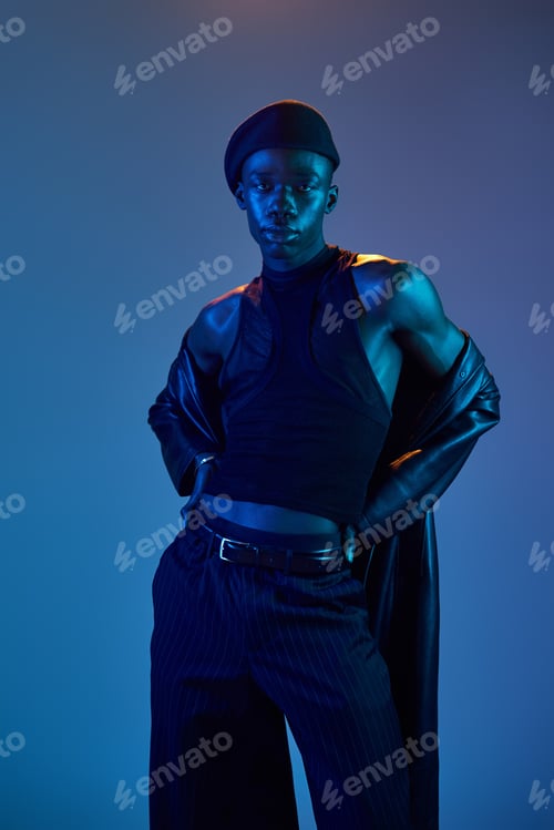 Preview: Vibrant young man showcases stylish fashion with confidence and charisma in a captivating setting