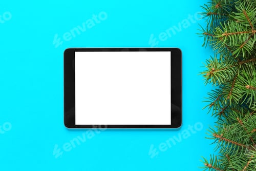 Preview: blank screen tablet on blue background, christmas time top view