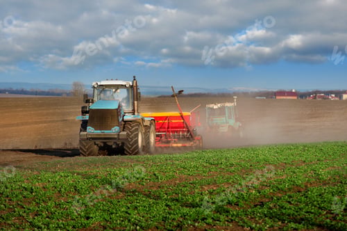 Preview: tractors sowing in the field, cloud of dust, prepare the land