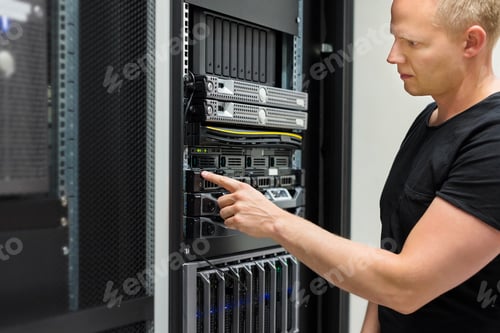 Preview: IT Technician Monitors Server On Rack In Datacenter