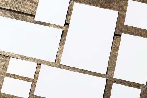 Preview: Blank white cards on wooden table in an organized layout for creative projects
