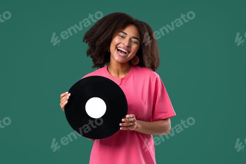 Preview: Pretty Woman Smiling With Vinyl Record Disc On green. Hobby, Music, Collection