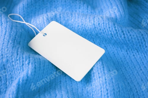 Preview: Template Of Blank Clothing Label, Price Tag On Blue Crumpled Knitted Sweater Background