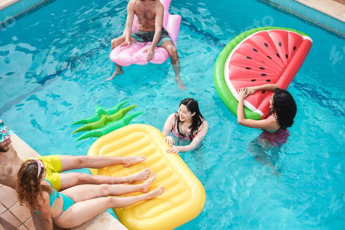 Preview: Happy friends having fun inside swimming pool during summer vacation - Focus on faces