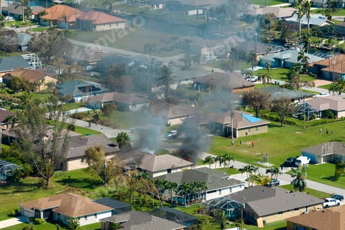 Preview: Burning residential house on fire with smoke and flames and firefighters extinguishing