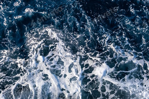 Vista previa: Top down aerial view of sea water surface. White foam waves texture as natural background.