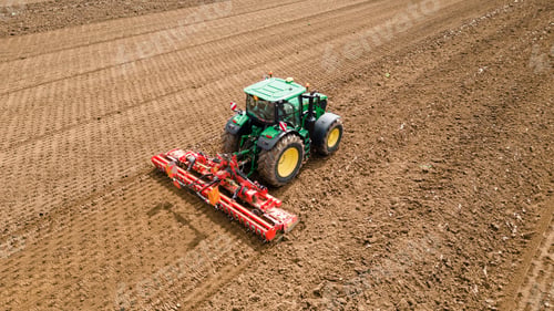 Preview: A picture of a rural farming community showcasing the use of farming machinery and equipment, such