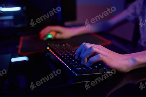 Preview: Gamer play computer game, use rgb neon colored keyboard