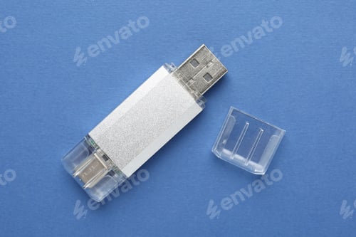 Preview: One flash drive on blue background, top view