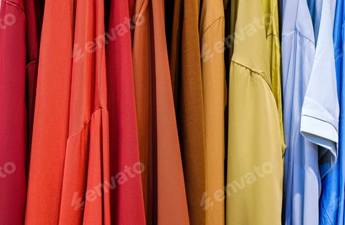 Preview: Fashionable clothes on a hanger. close - up of clothes in the store rainbow color.