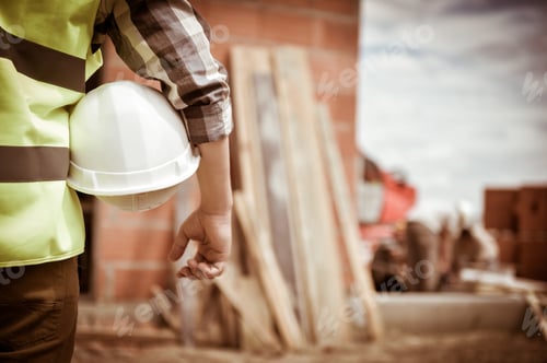 Preview: Worker Holding A Helmet With Background Of Construction Site, France