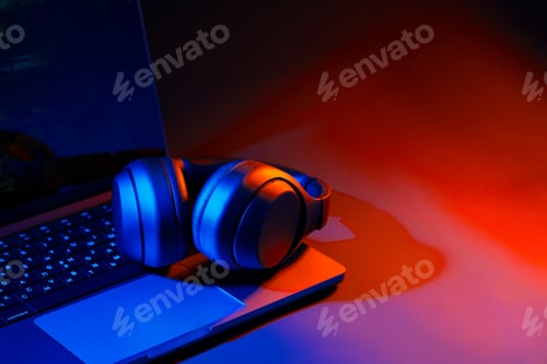 Preview: Headphones on a computer keyboard on black background