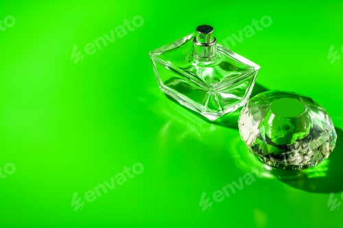 Preview: perfume glass bottle on light green background. Eau de toilette