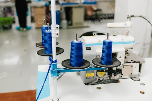 Preview: Thread spools placed on sewing machine for accurate tailoring of garments and apparel.