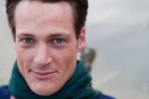 Preview: man with scarf looking at viewer