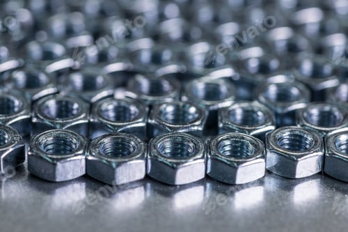 Preview: Close-up chrome metal nuts in the form of honeycombs