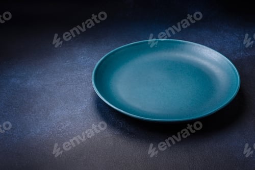 Preview: Round empty colored ceramic plate on concrete texture background