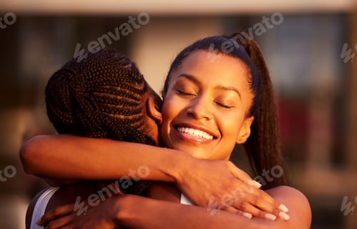 Preview: Shot of two attractive women hugging together while playing tennis outside