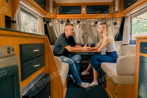 Preview: A couple in love a guy and a girl are sitting on date in a mobile home and gently holding hands