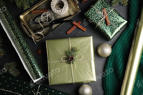 Preview: Flat lay composition with beautifully wrapped gift boxes on black table