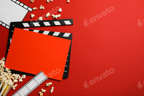 Preview: Clapperboard, paper cup with popcorn, film and reel on red background, space for text