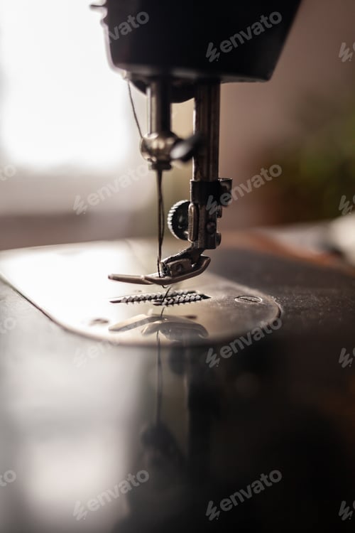 Preview: Old sewing machine stands on the table at home ready to work and sew.