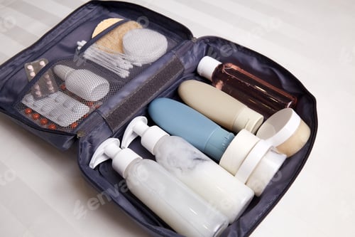 Preview: A toiletry bag is open on a flat surface, showcasing neatly arranged bottles of shampoo