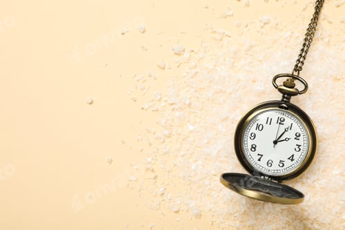 Preview: Pocket watch with snow on a light background.