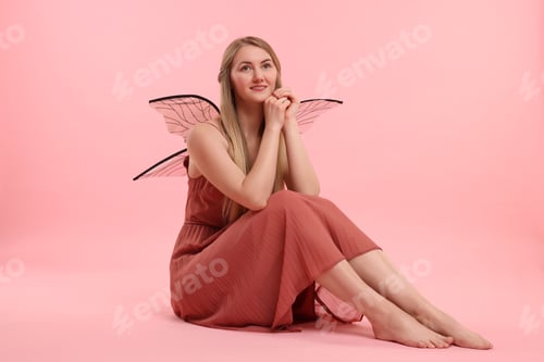 Preview: Beautiful girl in fairy costume with wings on pink background