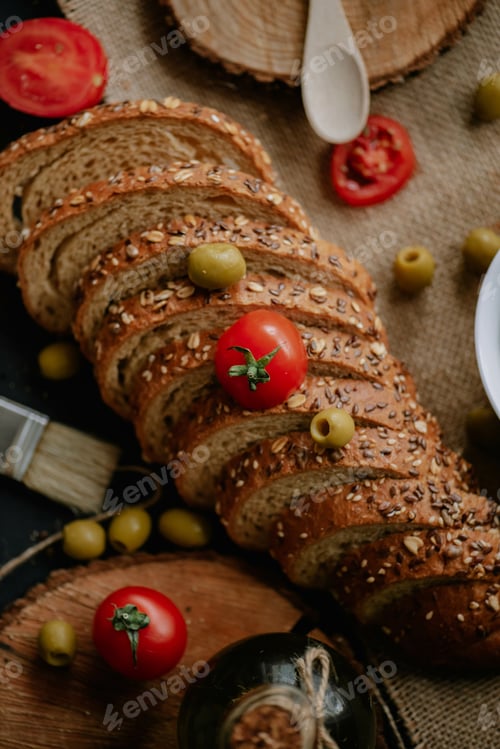 Preview: Top view of whole grain wheat bread with tomatoes and green olives