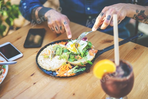 Preview: Young man eating health food - Tattooed hand guy portrait having brunch in bar restaurant