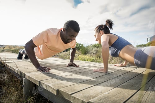 Preview: Couple doing push ups on wooden pathway