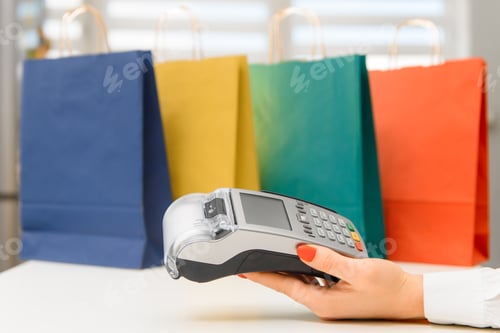 Preview: Closeup female hand holds terminal pay