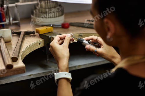 Preview: A skilled artisan meticulously crafting an exquisite jewel in a creative workshop