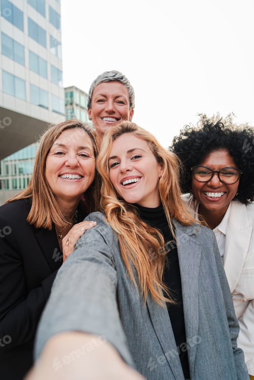Preview: Vertical portrait. Group of real successful business woman smiling and having fun taking a selfie