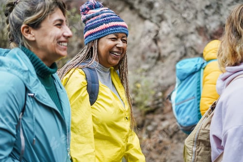 Preview: Multiracial women having fun during trekking day in to the wood - Focus on african senior face