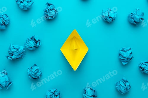 Preview: Great Idea Concept With Crumpled Office Paper And Yellow Paper Ship