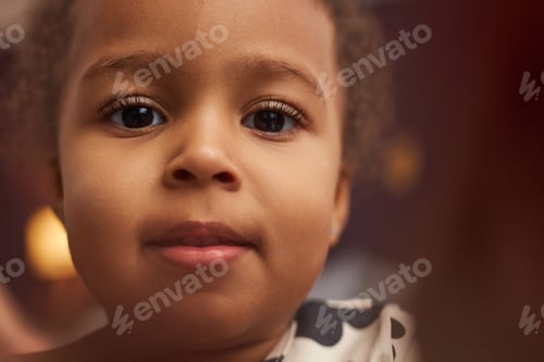 Preview: Close up cute Black little girl with big eyes looking at camera