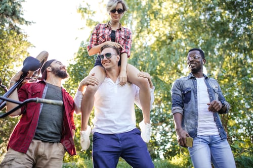 Preview: Diverse students relaxing outdoor after classes in college campus.