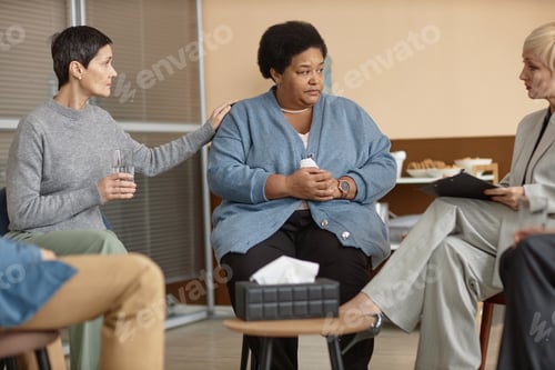 Preview: African American Senior Woman Listening to Female Therapist