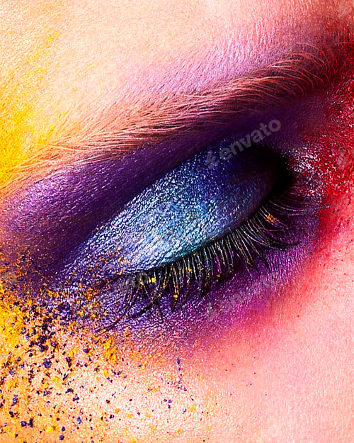 Preview: Studio shot of young woman's eye with multi coloured powder eye shadow, close up
