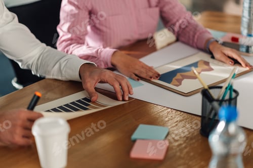 Preview: Business people analyzing charts and graphs during meeting