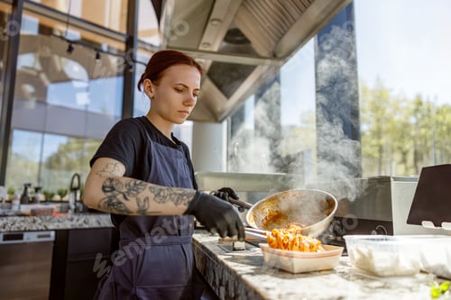 Preview: A talented chef is meticulously preparing an exquisite gourmet dish in a sleek modern kitchen