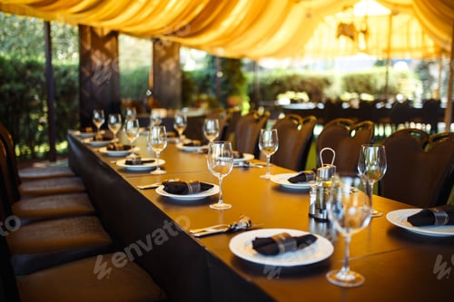 Preview: Sparkling glassware stands on long table prepared for wedding dinner.