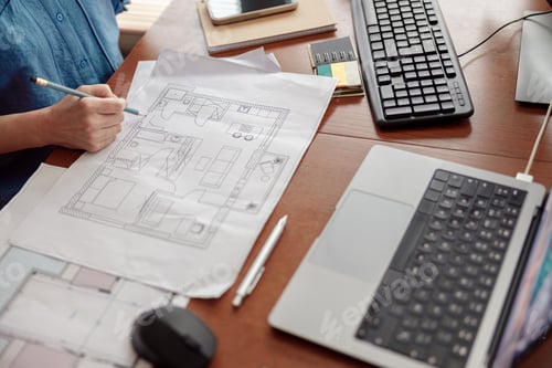 Preview: Woman engineer construction is developing construction project documentation sitting at home office