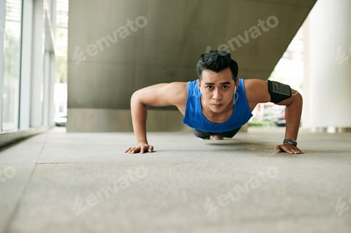Preview: Asian man doing plank exercise