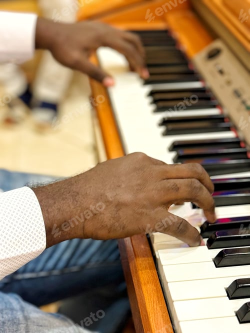 Preview: An unrecognizable diverse male musician plays piano professionally and skillfully with his hands