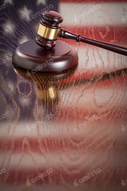 Preview: Wooden Gavel Resting on Flag Reflecting Table