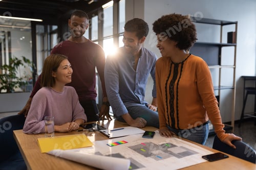 Preview: Diverse group of business people working in creative office